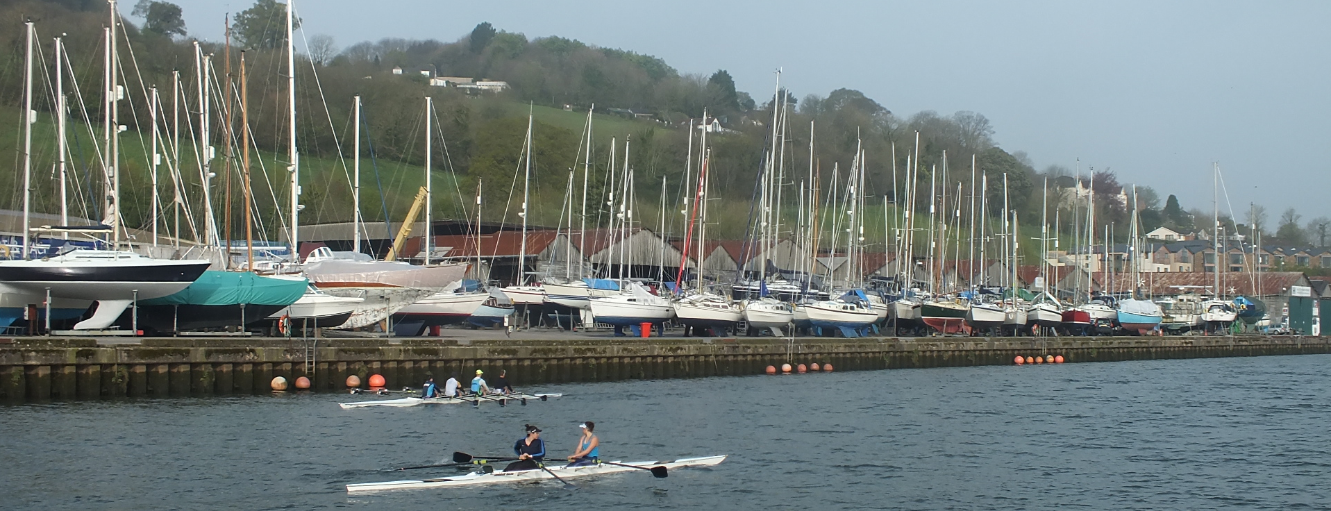 Long view of Baltic Wharf with boats along the river Dart